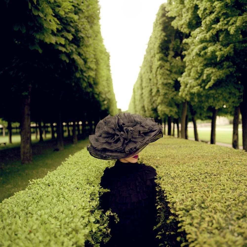 Woman with Hat between Hedges, Parc de Sceaux, France,  2004© Rodney Smith
