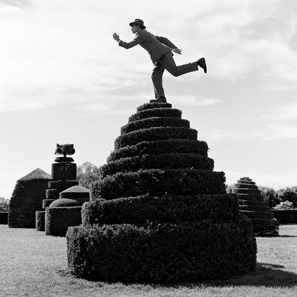 Reed Balancing on top of Topiary, Longwood Gardens, Pennsylvania, 2013© Rodney Smith
